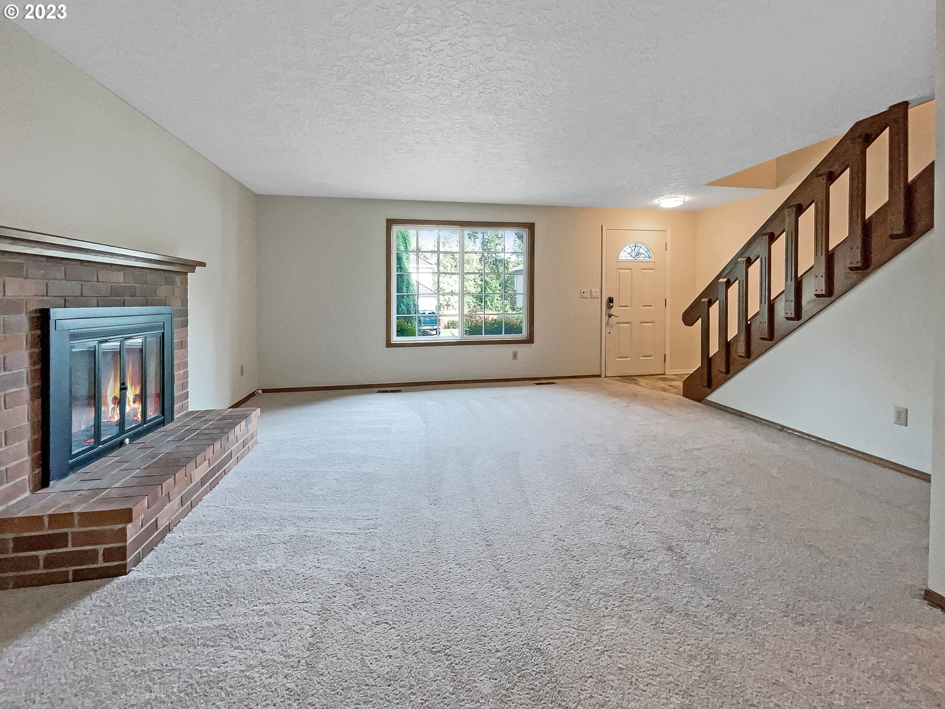 2120 Southwest 30th Drive Gresham, OR 97080 - Photo 3 of 17 a view of an empty room with fireplace and windows