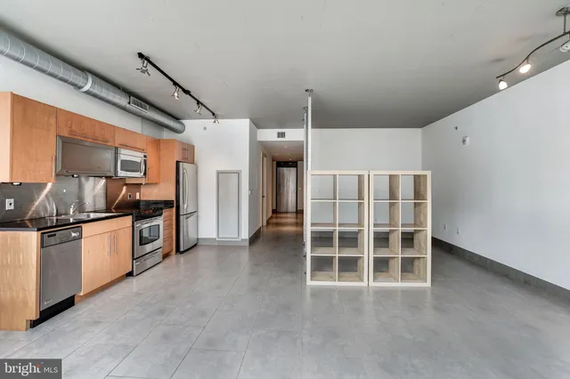 a view of a kitchen with large windows