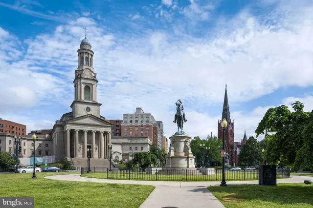 front view of a residential apartment building with a yard