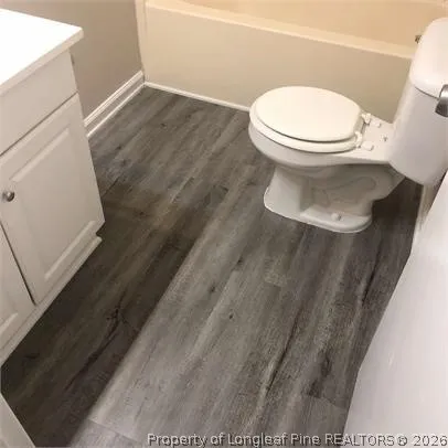 a white toilet sitting next to a sink