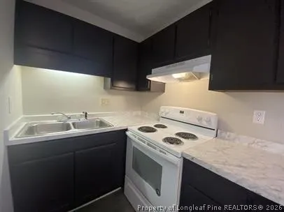 a kitchen that has a sink and a stove