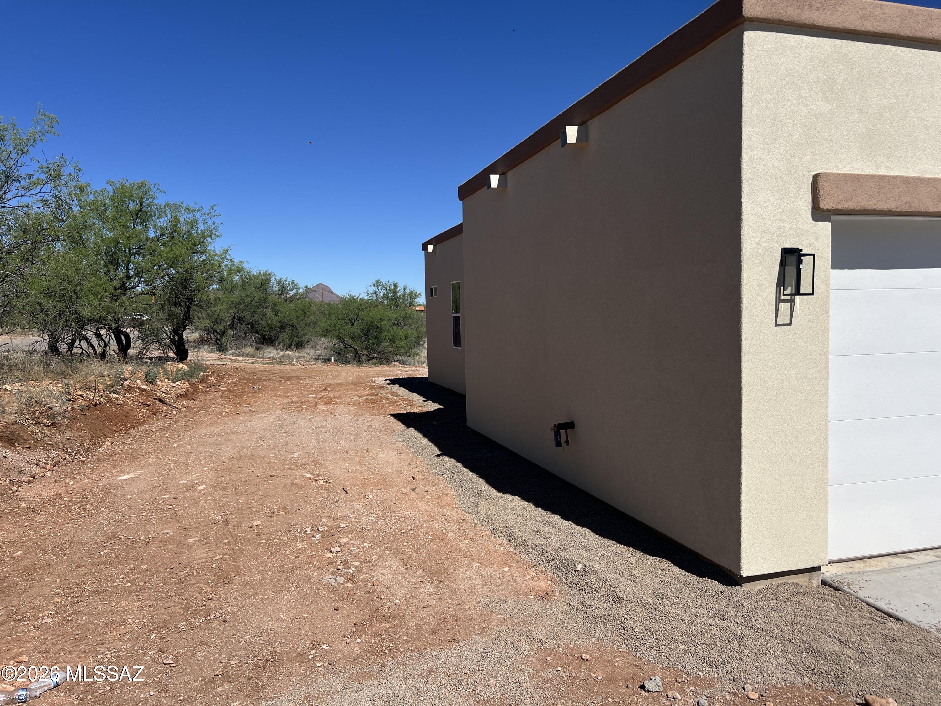 1501 Circulo Sombrero Rio Rico, AZ 85648 - Photo 4 of 26 a backyard of a house with lawn chairs and couches
