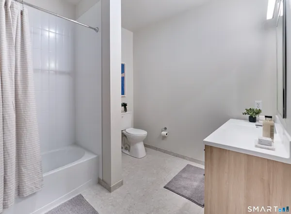 a bathroom with a sink a toilet and a bathtub