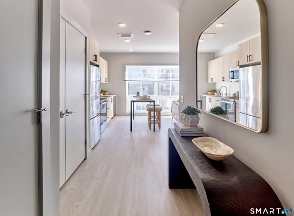 a dining room with furniture and a wooden floor