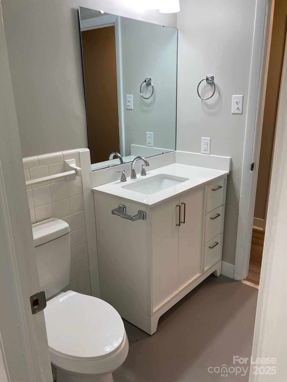 1697 Morningside Drive Newton, NC 28658 - Photo 18 of 22 a bathroom with a granite countertop toilet sink and mirror