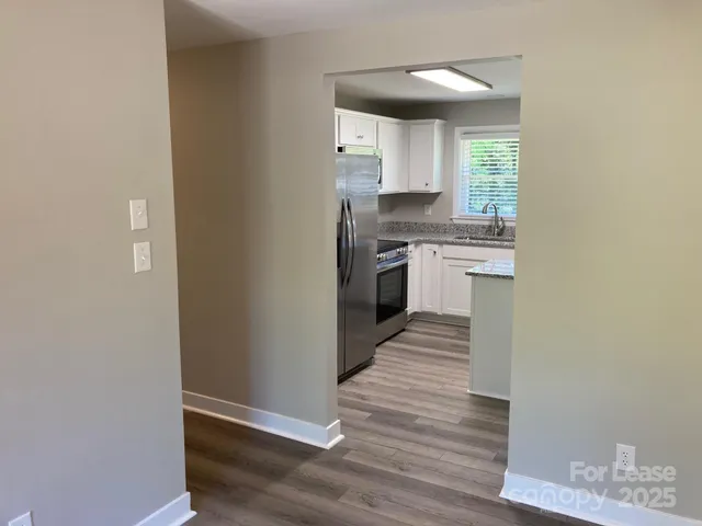 a kitchen with granite countertop white cabinets and appliances