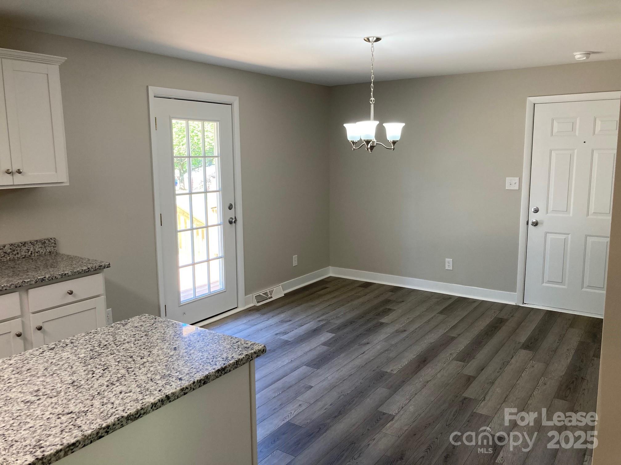 1697 Morningside Drive Newton, NC 28658 - Photo 9 of 22 wooden floor in an empty room with a window