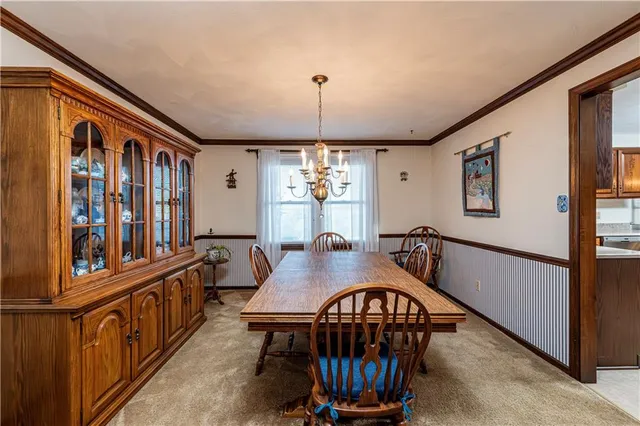 a dining room with furniture window and wooden floor