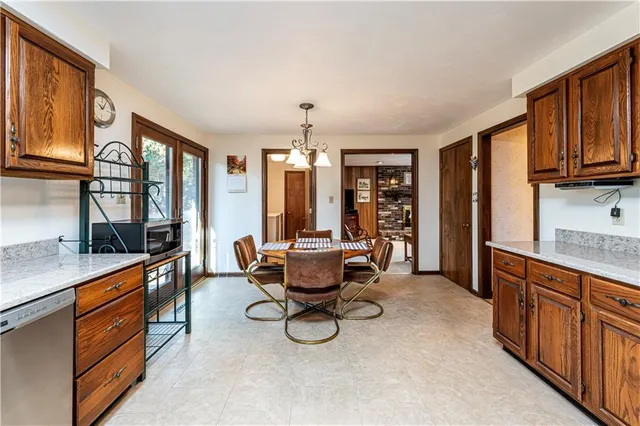 a living room with furniture a flat screen tv and large window