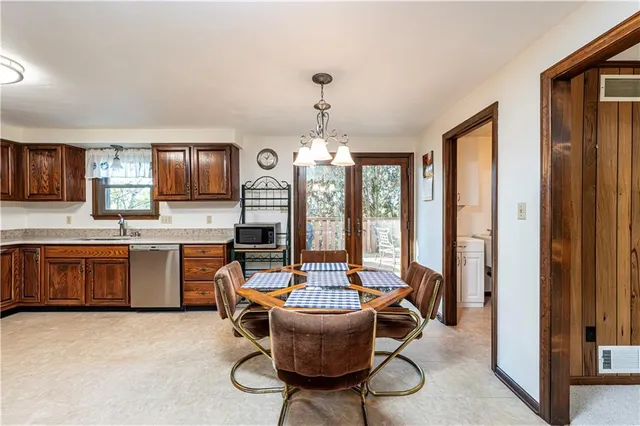 a living room with furniture a chandelier and a window