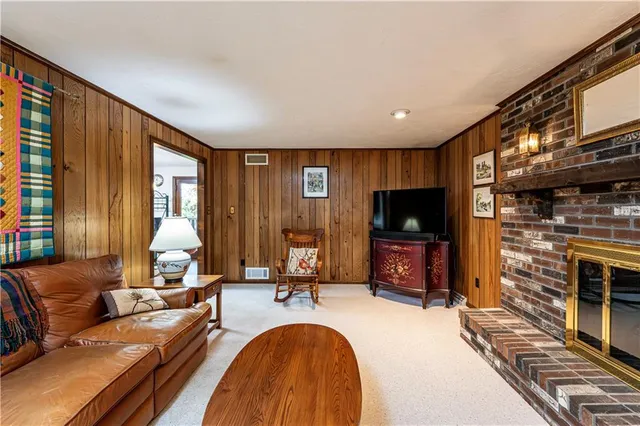 a living room with fireplace furniture and a flat screen tv