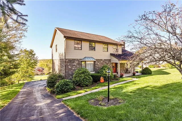 a house that has a tree in front of it