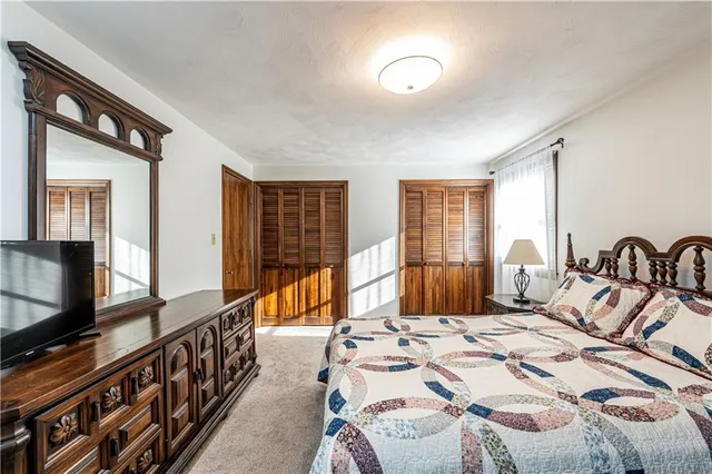 a bedroom with double bed and a flat screen tv
