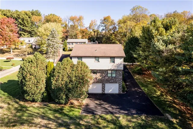 an aerial view of a house with a yard