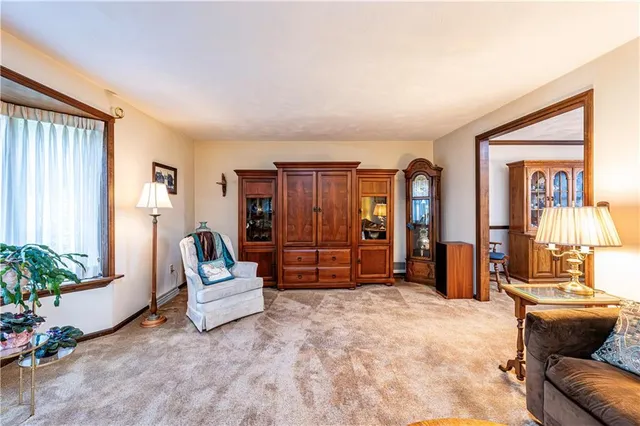 a living room with furniture and flowers
