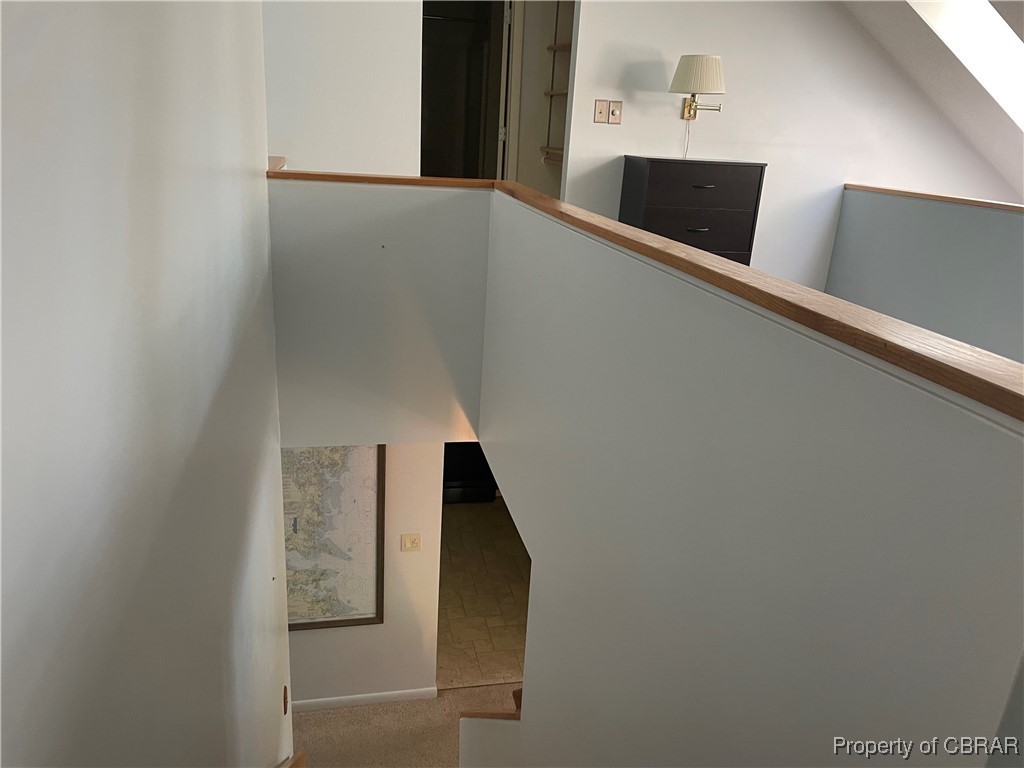 68 Villa Ridge Drive, Unit 4F Hartfield, VA 23071 - Photo 18 of 23 Stairs featuring carpet and a skylight