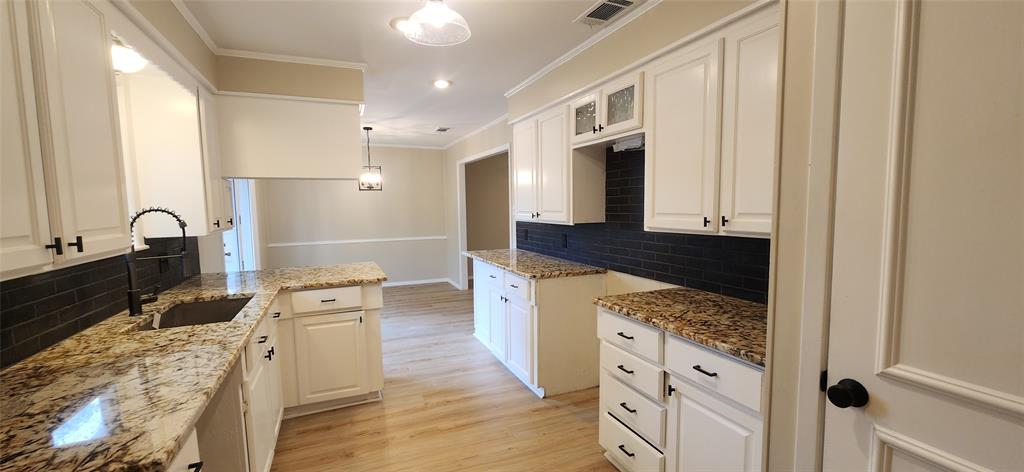 2821 Windy Drive Commerce, TX 75428 - Photo 15 of 25 a large kitchen with stainless steel appliances granite countertop a sink stove and refrigerator