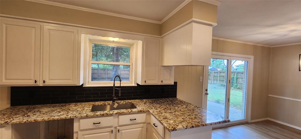2821 Windy Drive Commerce, TX 75428 - Photo 17 of 25 a kitchen with granite countertop a sink and a stove