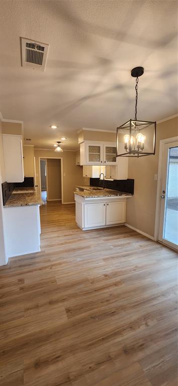 2821 Windy Drive Commerce, TX 75428 - Photo 18 of 25 a view of a kitchen with kitchen island a sink stainless steel appliances and cabinets