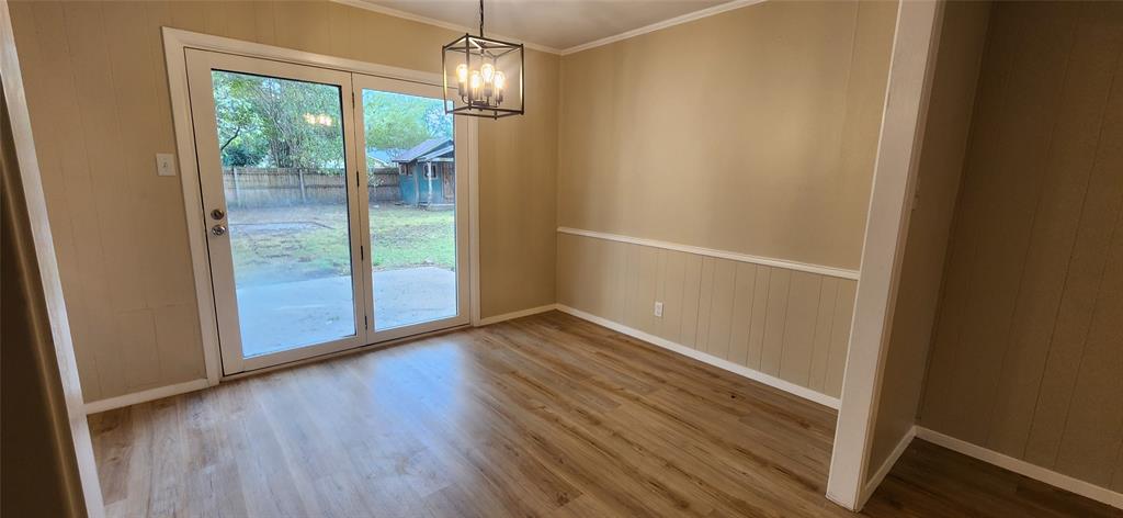 2821 Windy Drive Commerce, TX 75428 - Photo 19 of 25 a view of empty room with wooden floor and fan
