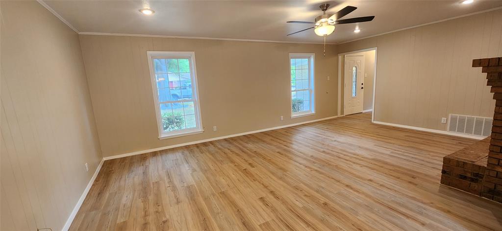2821 Windy Drive Commerce, TX 75428 - Photo 20 of 25 wooden floor in an empty room with a window