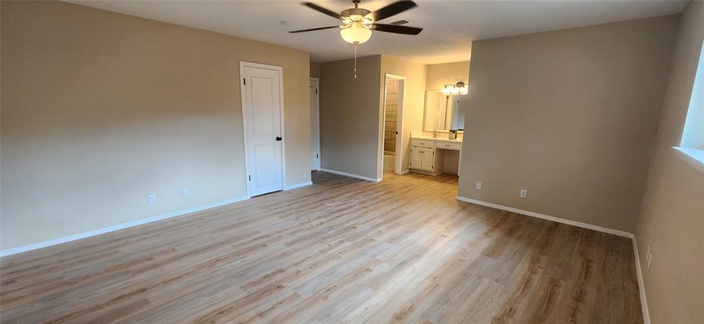 2821 Windy Drive Commerce, TX 75428 - Photo 22 of 25 wooden floor in an empty room with a window