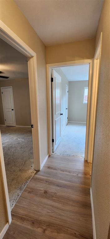 2821 Windy Drive Commerce, TX 75428 - Photo 8 of 25 a view of a hallway with wooden floor