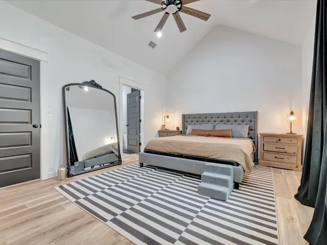a bedroom with a bed a rug and dresser
