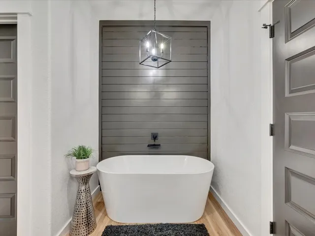 a bathroom with a bathtub and shower