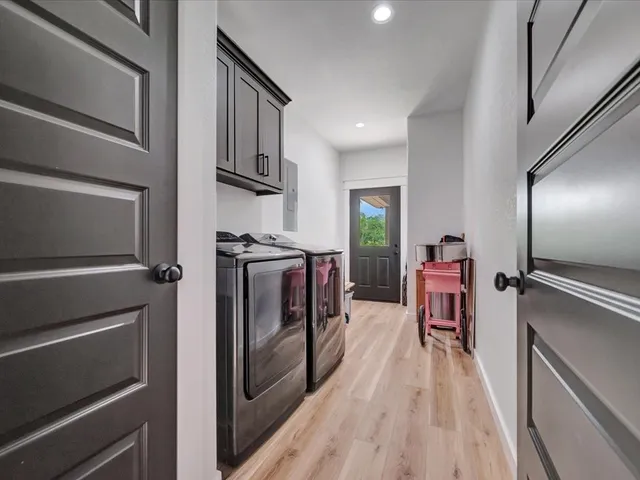 a kitchen with granite countertop stainless steel appliances a stove top oven and a refrigerator