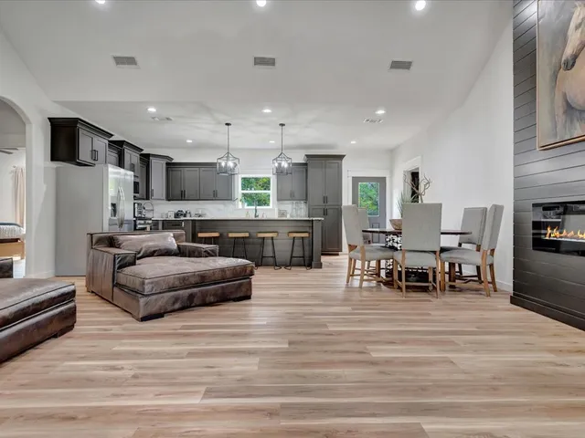 a living room with kitchen island furniture and a wooden floor