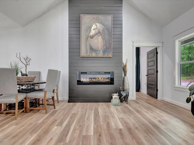 a room with painting on the wall and a table