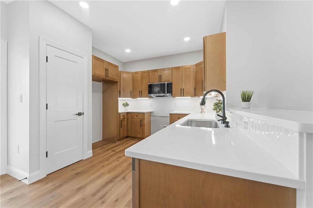16 Margaret Street Uniontown, PA 15401 - Photo 26 of 50 a kitchen with kitchen island a sink appliances and cabinets