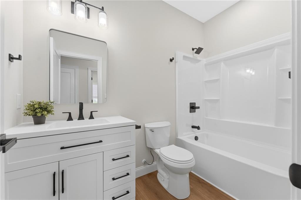 16 Margaret Street Uniontown, PA 15401 - Photo 35 of 50 a bathroom with a bathtub shower sink vanity mirror and toilet