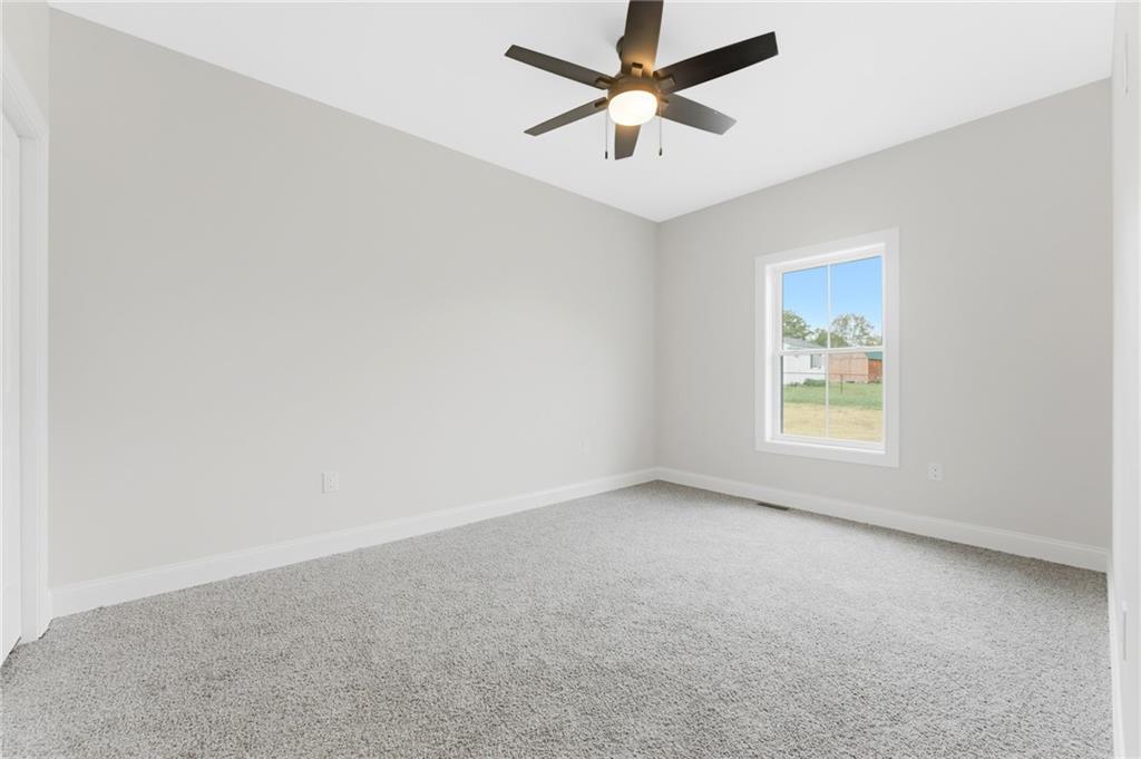 16 Margaret Street Uniontown, PA 15401 - Photo 41 of 50 an empty room with a window and a fan