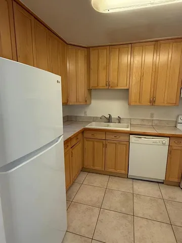 a kitchen with a cabinets and white stainless steel appliances