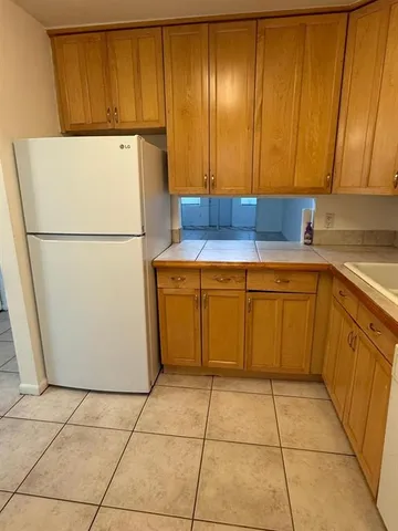 a white refrigerator freezer sitting in a kitchen