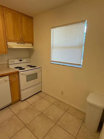 a kitchen with a stove a sink and a microwave
