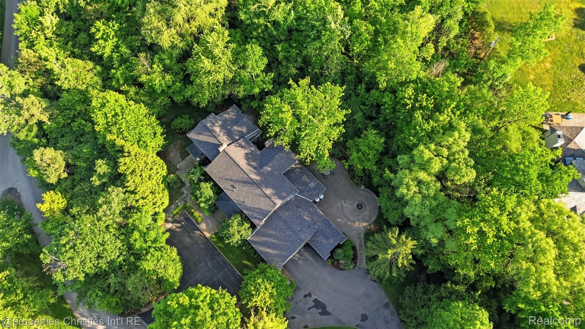 25235 Canterbury Road Franklin, MI 48025 - Photo 48 of 56 Expansive property featuring a dark shingle roof, surrounded by mature trees