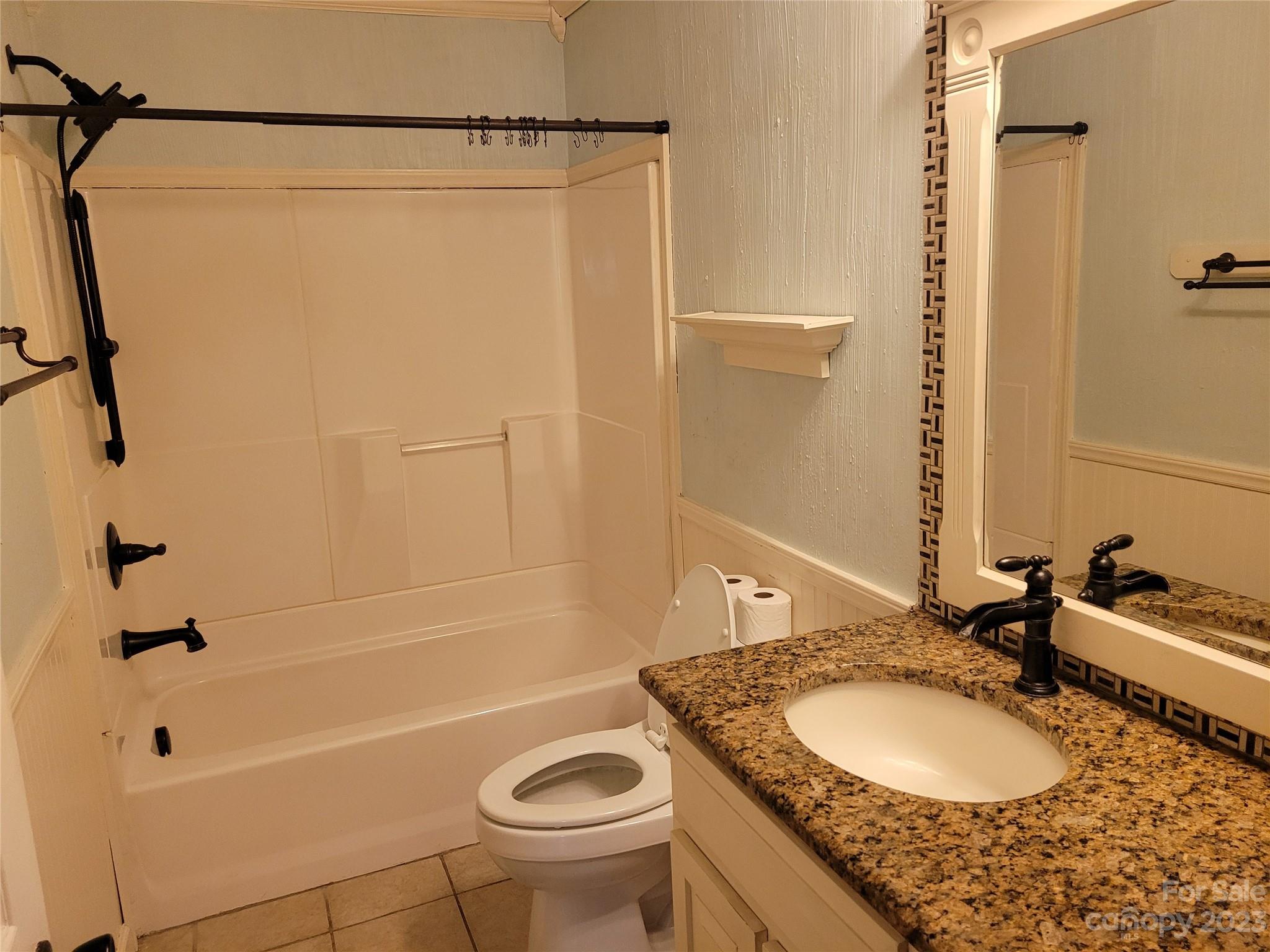 1740 Sells Road Salisbury, NC 28144 - Photo 16 of 22 a bathroom with a granite countertop sink a toilet and shower