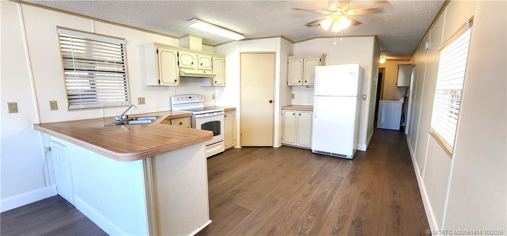 1601 Highway 441, Unit 3 Okeechobee, FL 34974 - Photo 6 of 17 a kitchen with stainless steel appliances granite countertop a sink a refrigerator and a stove