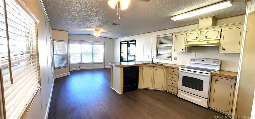 1601 Highway 441, Unit 3 Okeechobee, FL 34974 - Photo 7 of 17 a kitchen with stainless steel appliances granite countertop a stove a sink and a refrigerator