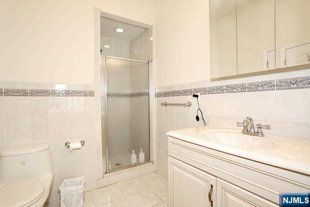 84 12th Street Cresskill, NJ 07626 - Photo 34 of 45 a bathroom with a sink a toilet and shower