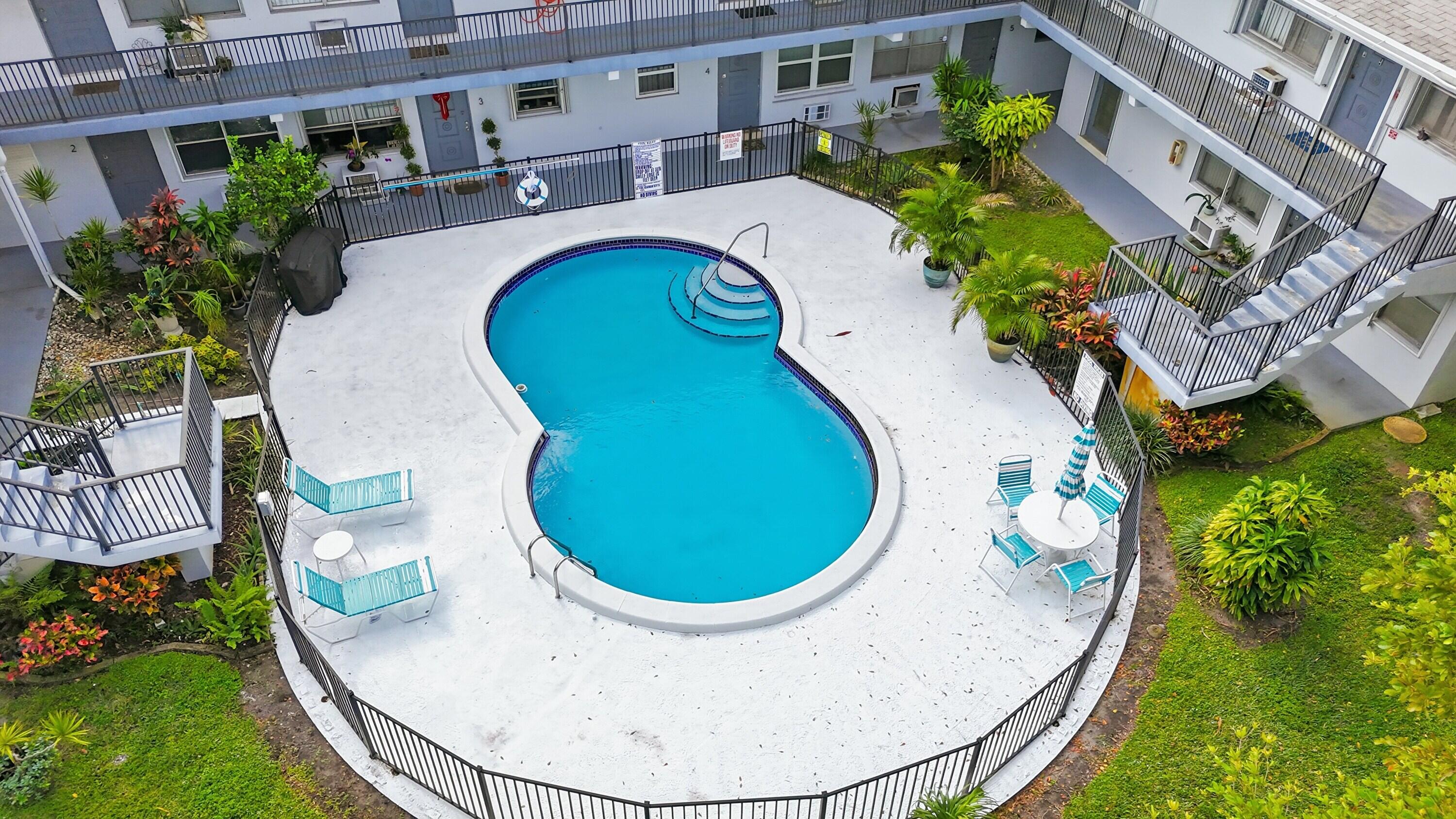 3510 Harrison Street, Unit 4 Hollywood, FL 33021 - Photo 23 of 31 an aerial view of a house with swimming pool and trees in the background