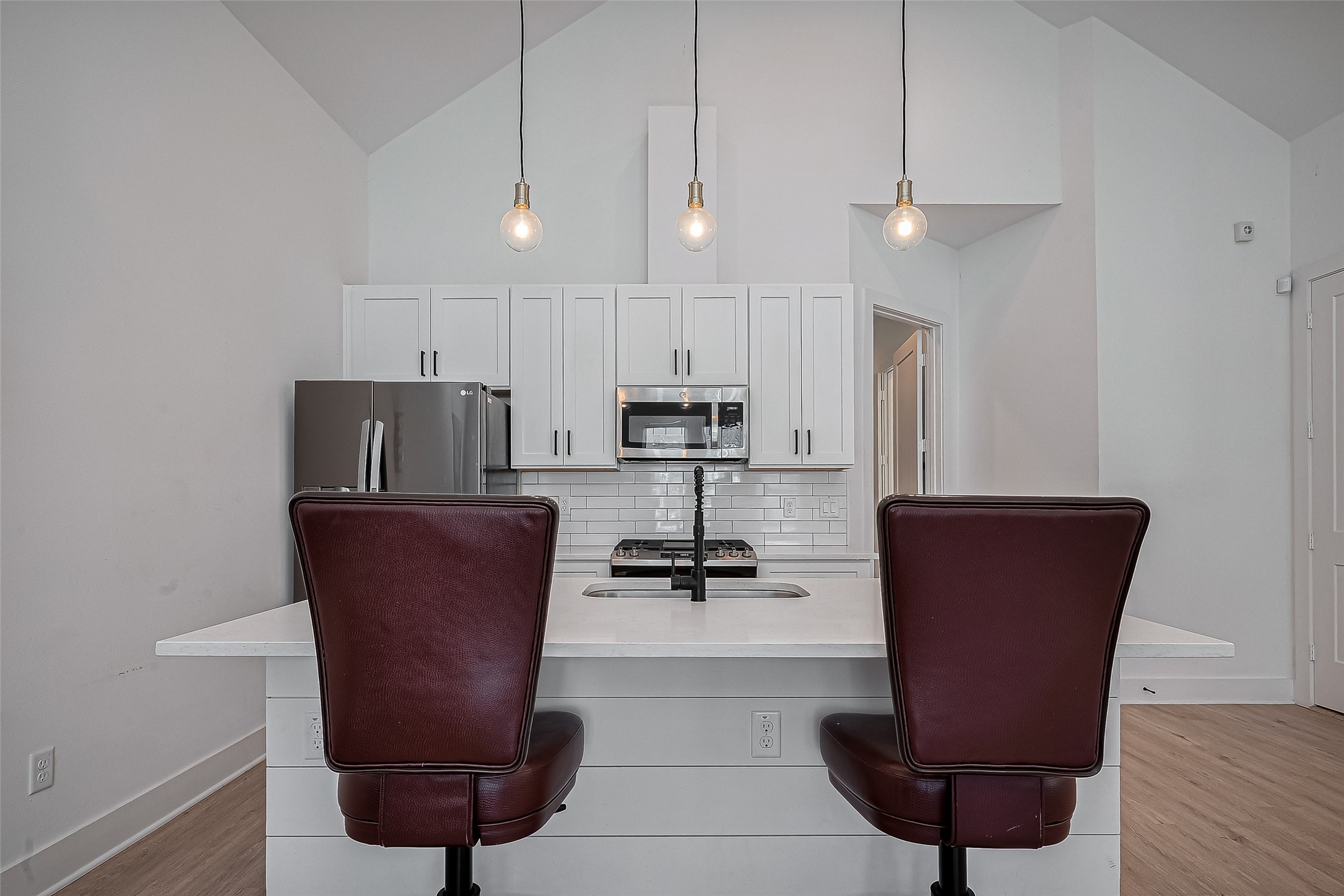 2518 Terry Street Houston, TX 77009 - Photo 5 of 17 Designer kitchen with oversized island seating, vaulted ceilings, and sleek contemporary finishes throughout.