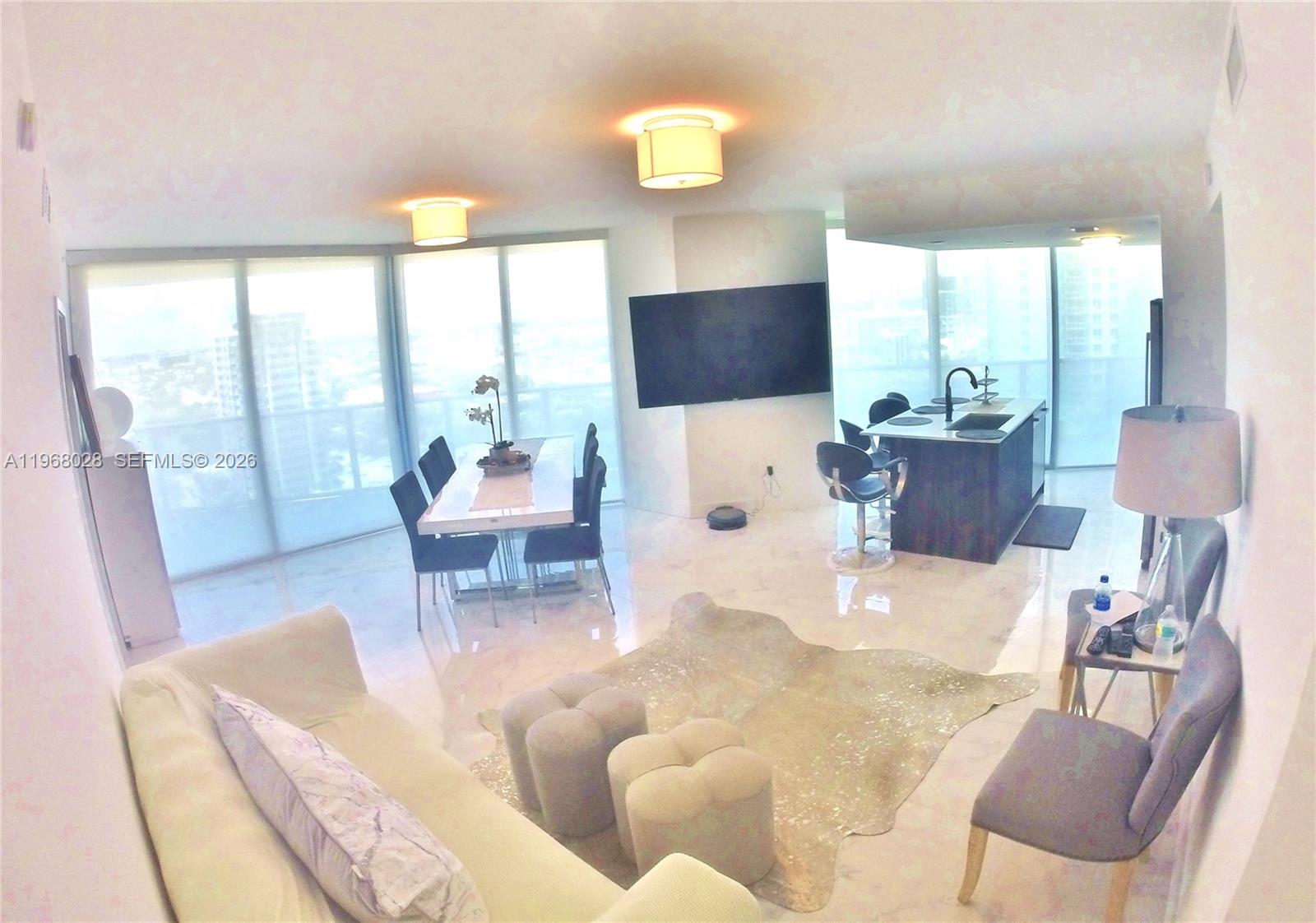 488 Northeast 18th Street, Unit 2001 Miami, FL 33132 - Photo 17 of 26 a living room with furniture and a large window