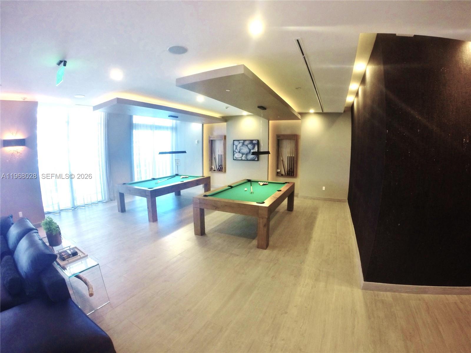 488 Northeast 18th Street, Unit 2001 Miami, FL 33132 - Photo 18 of 26 a lobby with furniture and floor to ceiling window