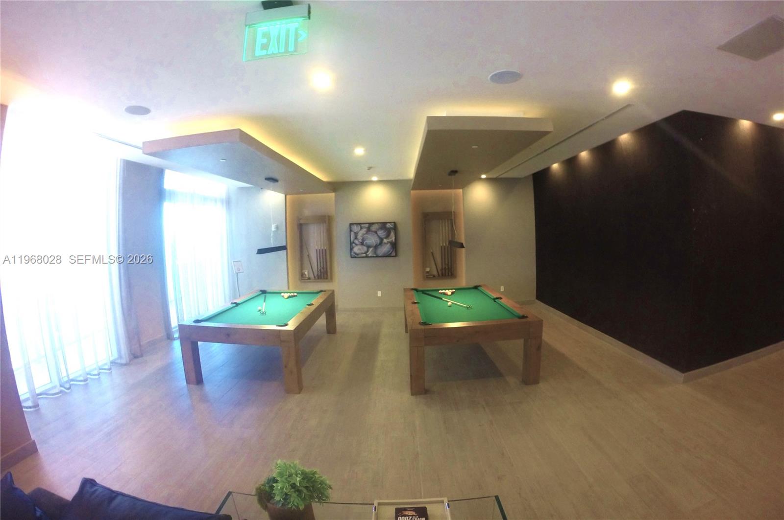 488 Northeast 18th Street, Unit 2001 Miami, FL 33132 - Photo 19 of 26 a lobby with furniture and a potted plant