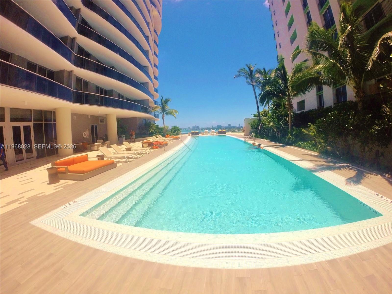 488 Northeast 18th Street, Unit 2001 Miami, FL 33132 - Photo 20 of 26 a view of a swimming pool with an outdoor seating