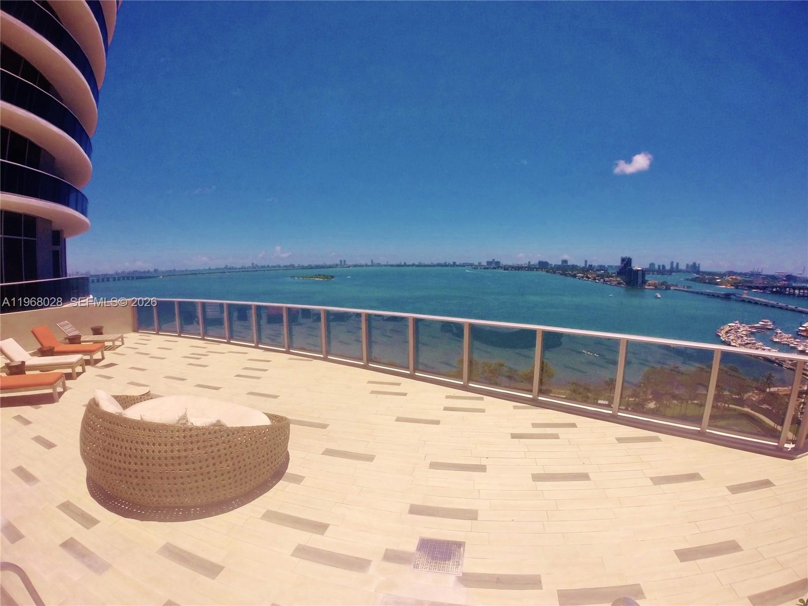 488 Northeast 18th Street, Unit 2001 Miami, FL 33132 - Photo 21 of 26 a view of a swimming pool with a lounge chair